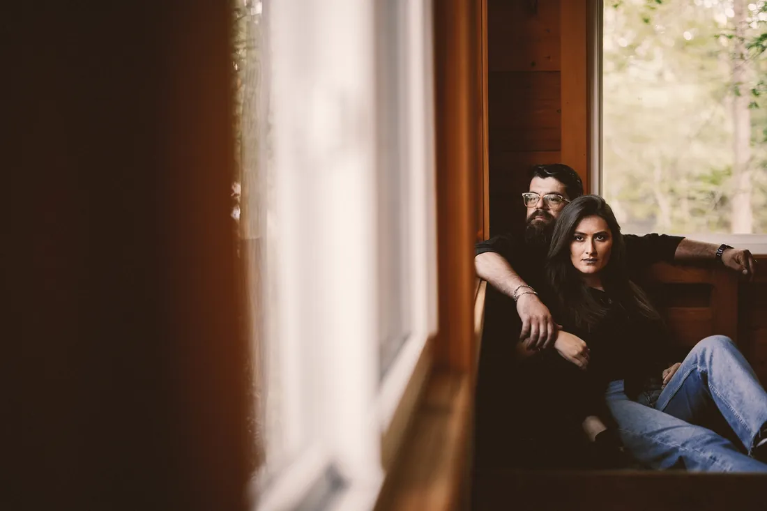 Engaged couple relaxing by a sunlit window