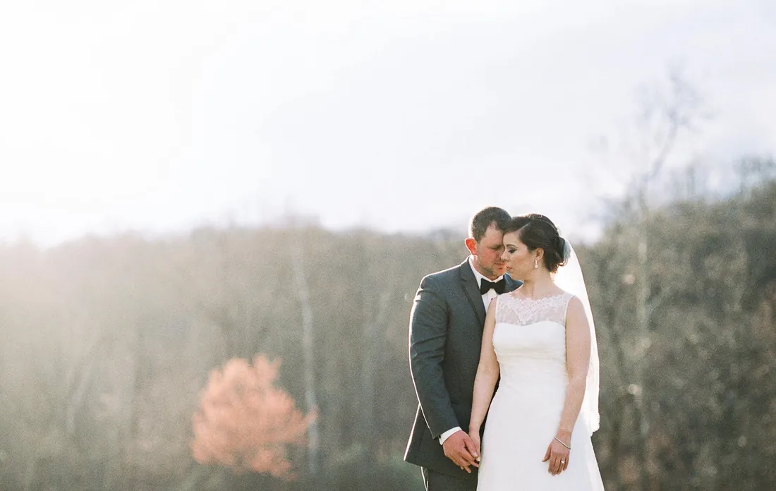 Film photograph of a bride and groom in soft autumn light