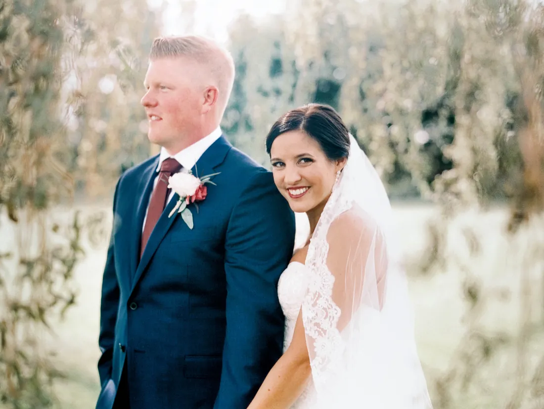 Film photograph of a smiling bride and groom outdoors