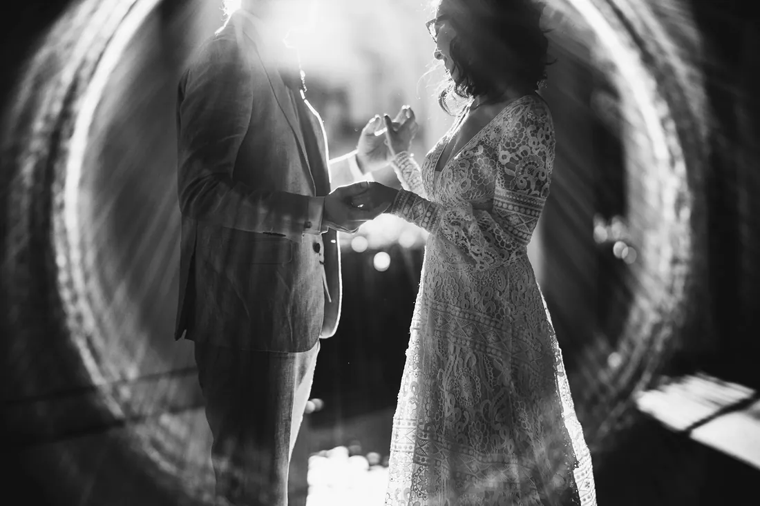 Black and white photo of a bride and groom framed in a circle of light