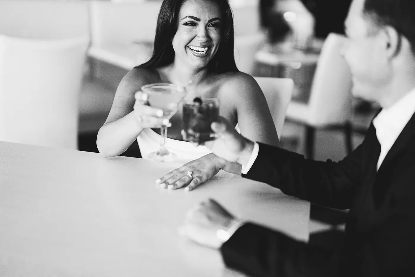 Black and white photo of Branon and Celeste clinking glasses