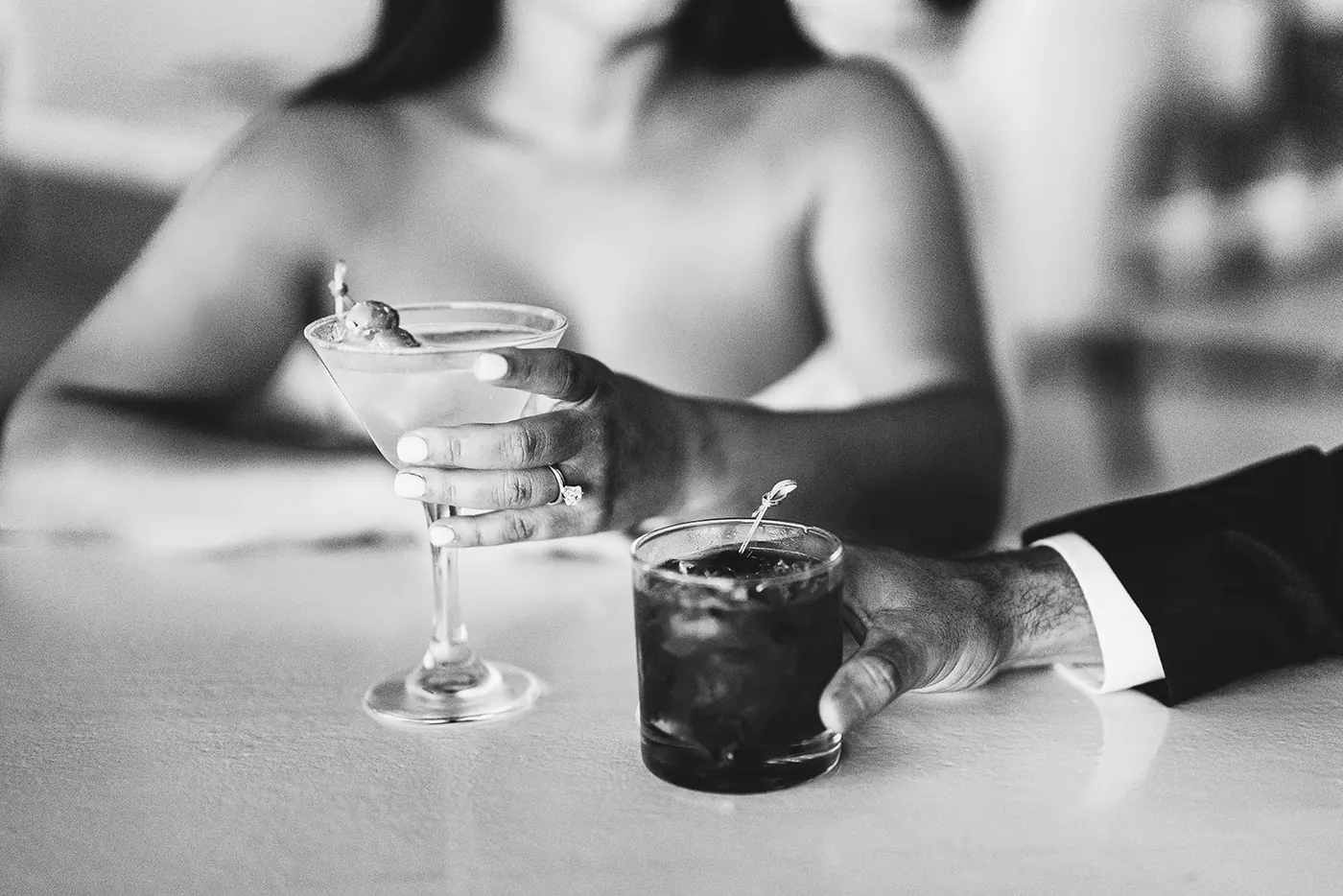 Black and white close-up of a martini and an old fashioned on the table
