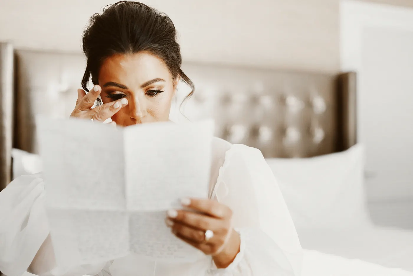Celeste wiping away a tear as she reads a letter from Branon