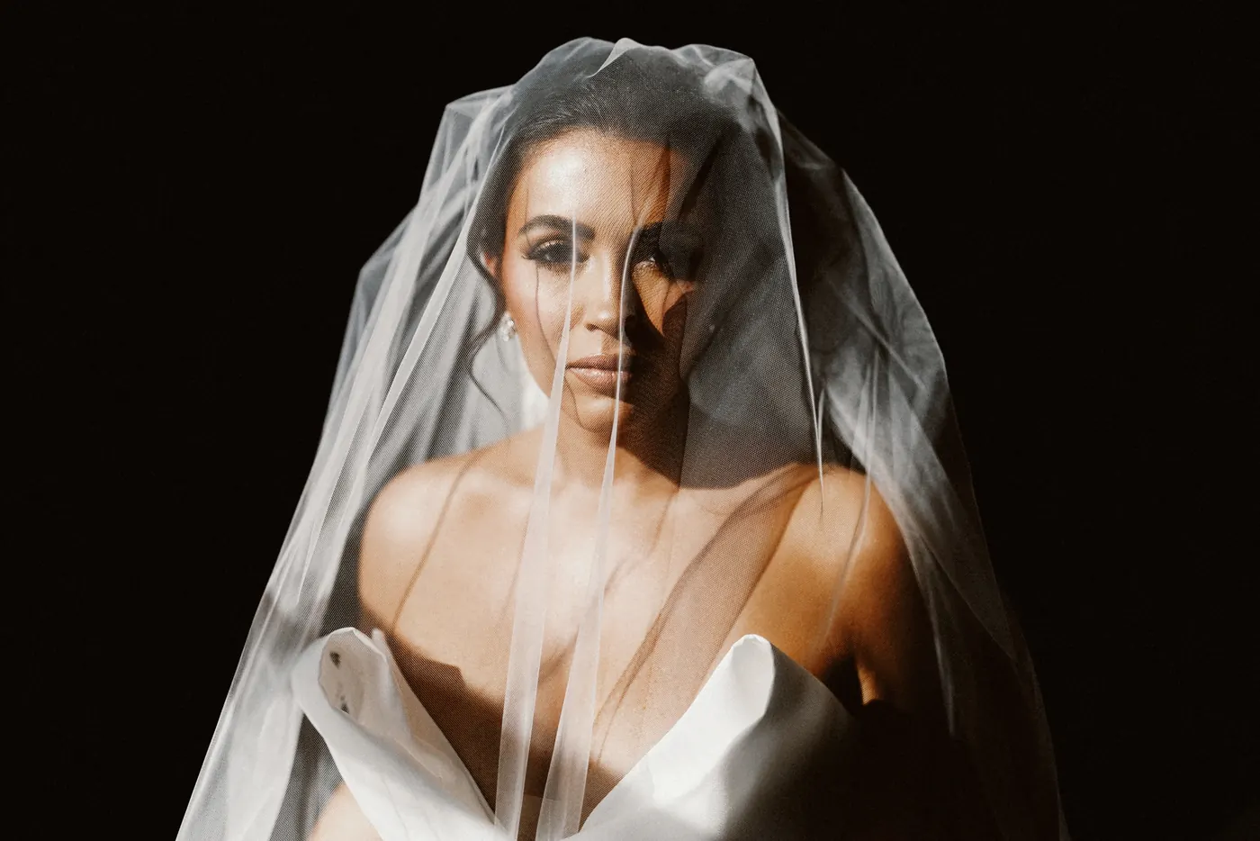 Celeste looking through her veil in soft light