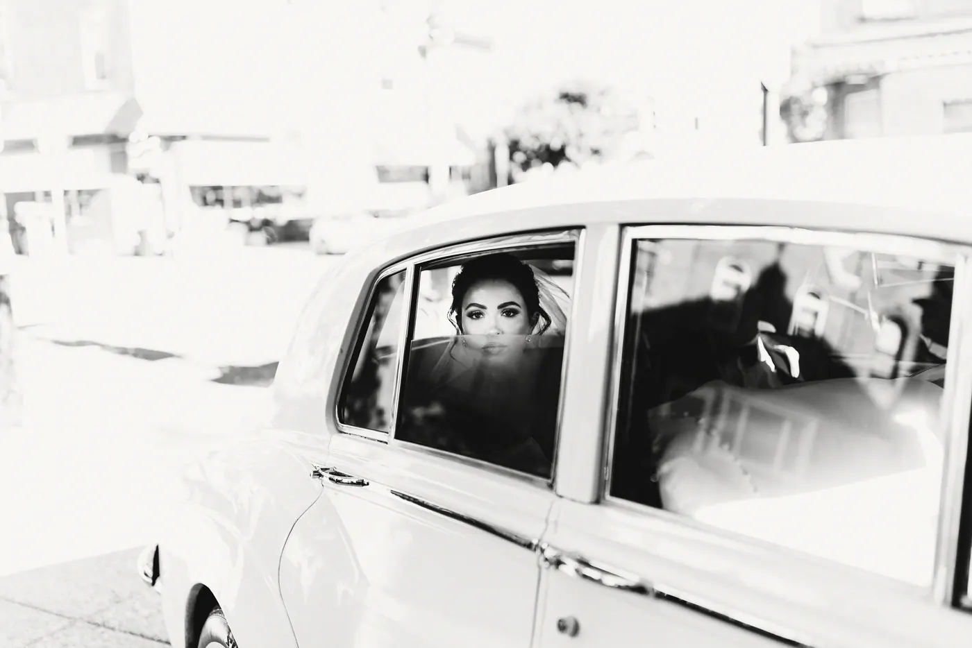 Black and white photo of Celeste arriving in a white vintage car