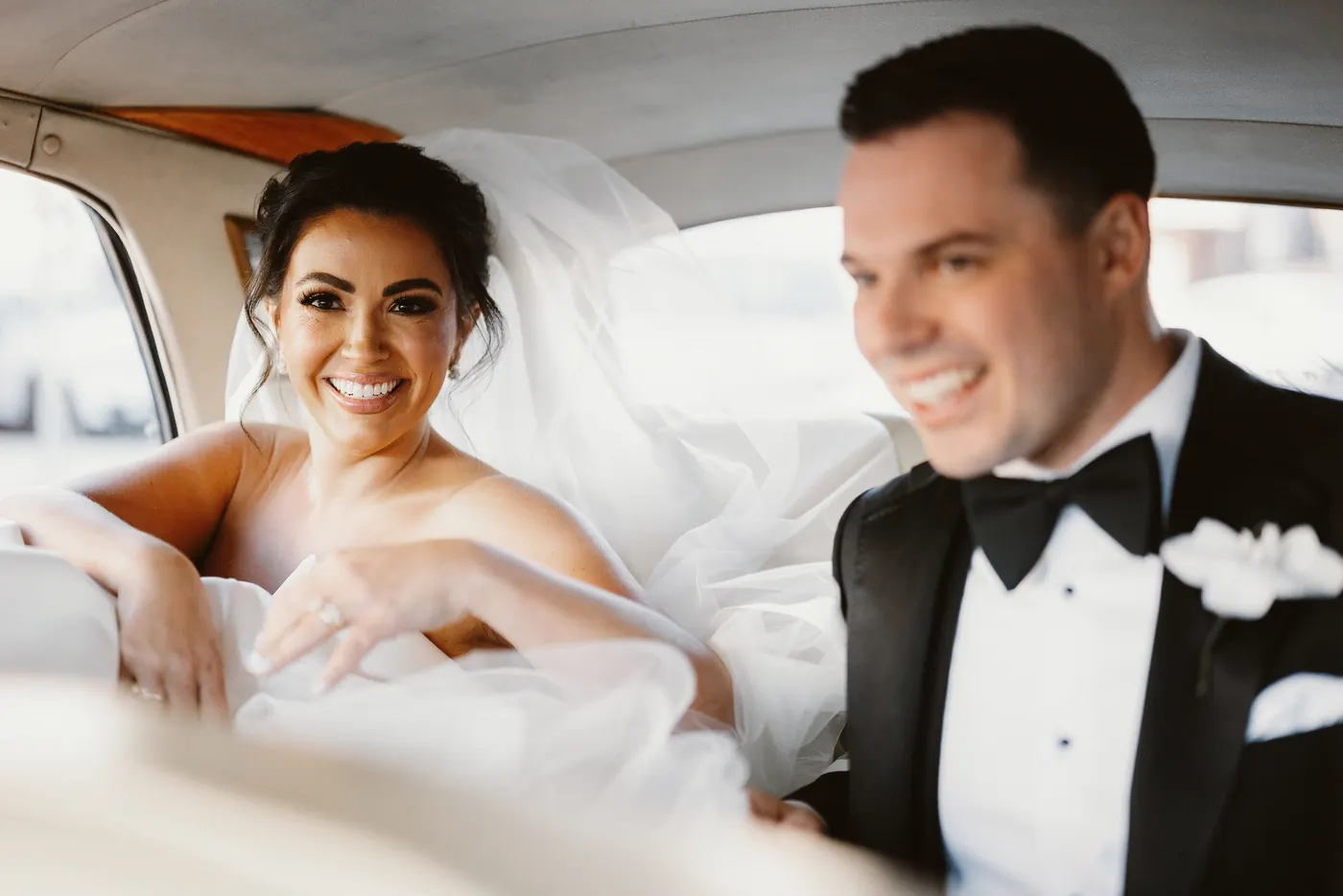 Branon and Celeste laughing in the back of the vintage car
