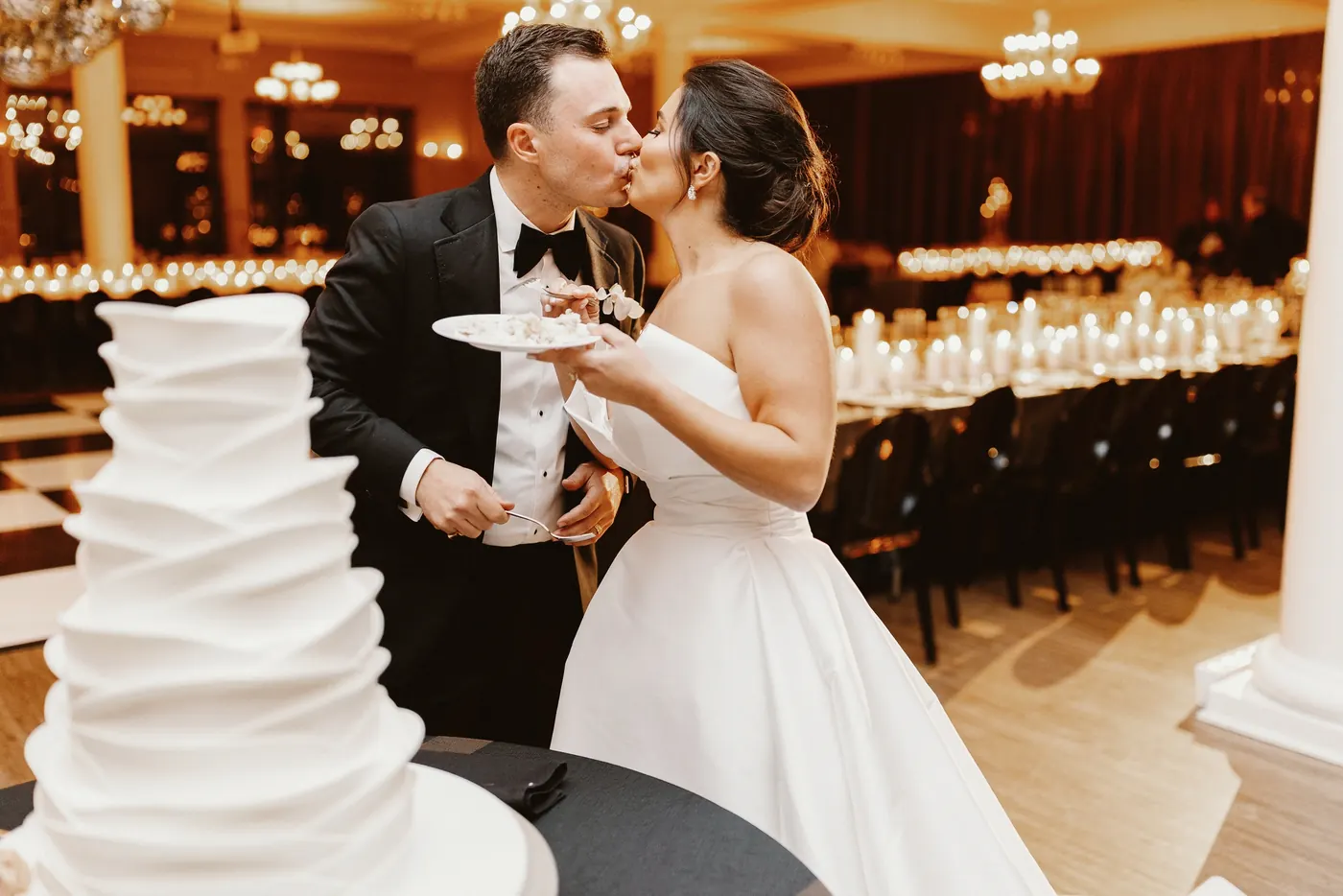 Branon and Celeste kissing after cutting the cake at The Vie by Cescaphe in Philadelphia
