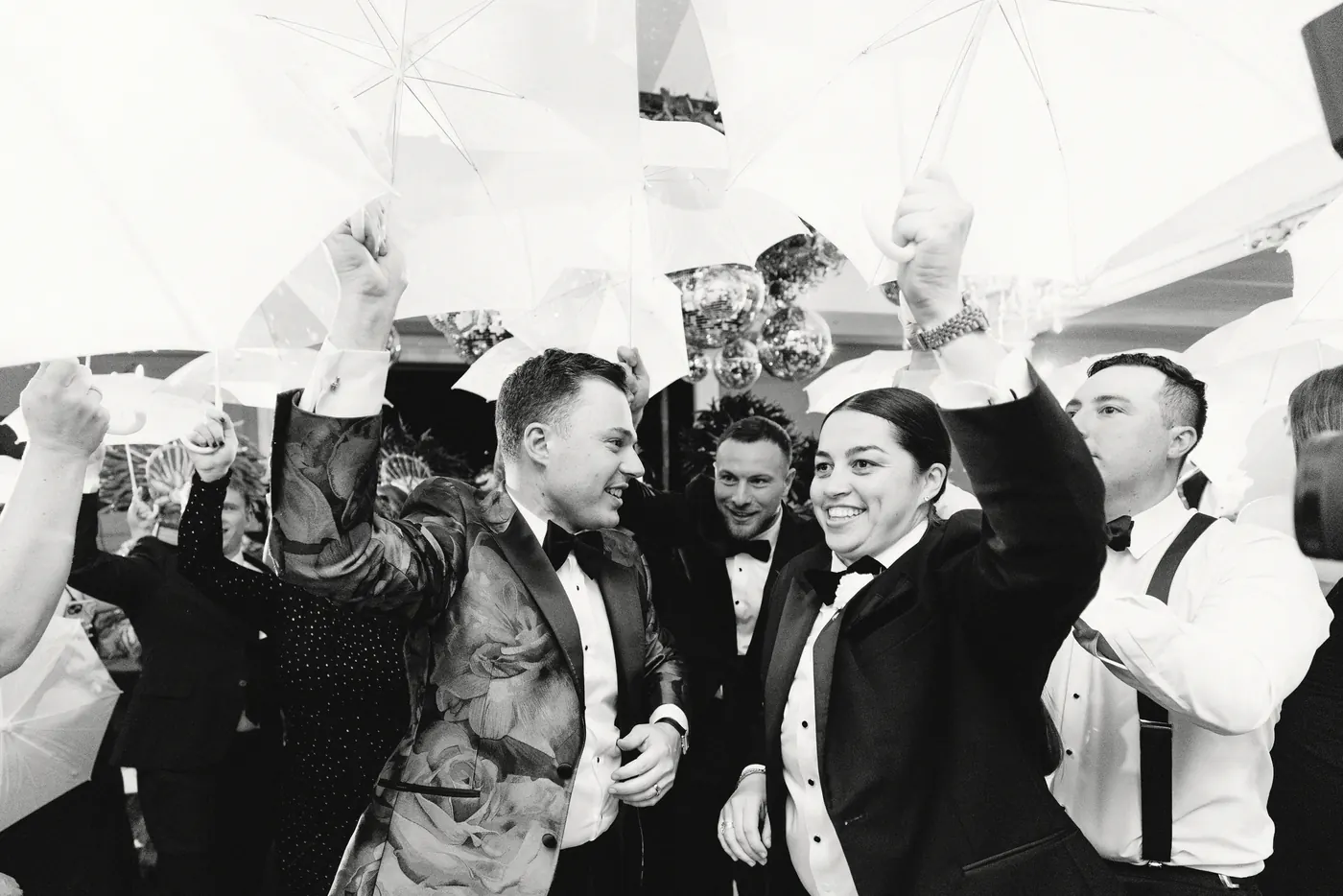 Black and white photo of guests dancing under white umbrellas at The Vie by Cescaphe in Philadelphia