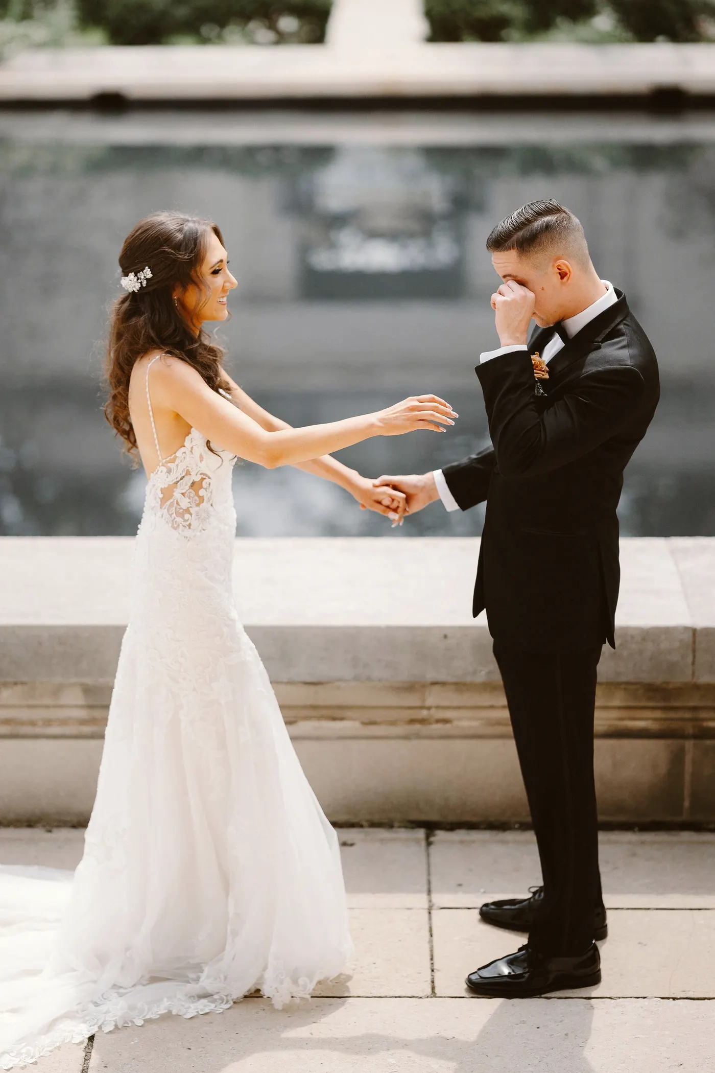 Chris tearing up as he holds Danielle's hands by the reflecting pool at the Rodin Museum in Philadelphia