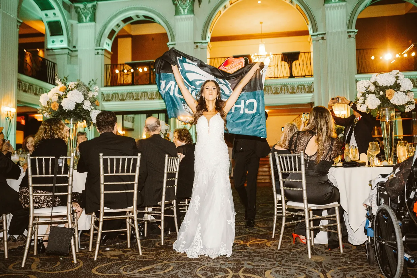 Danielle waving an Eagles jersey during the reception at Cescaphe Ballroom at the Ben in Philadelphia