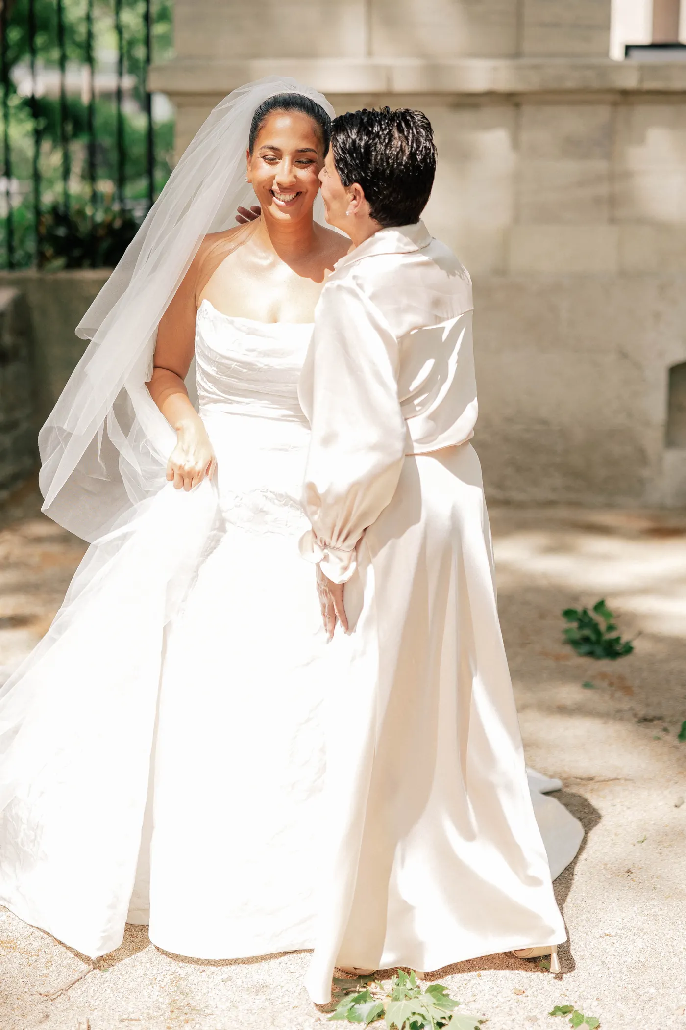 Gianna laughing as her mom kisses her cheek outside the Rodin Museum