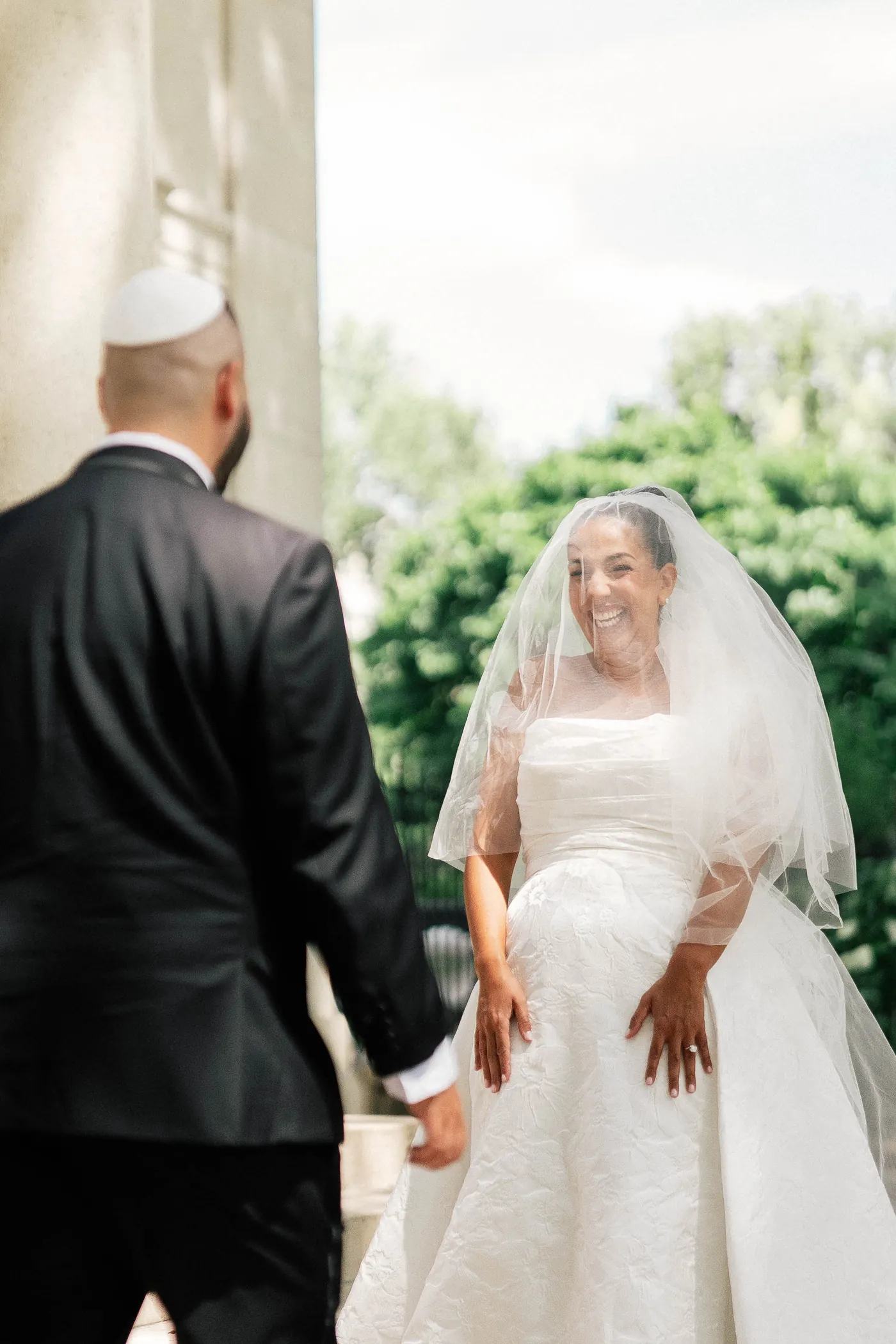 Gianna smiling as Simon turns around for their first look