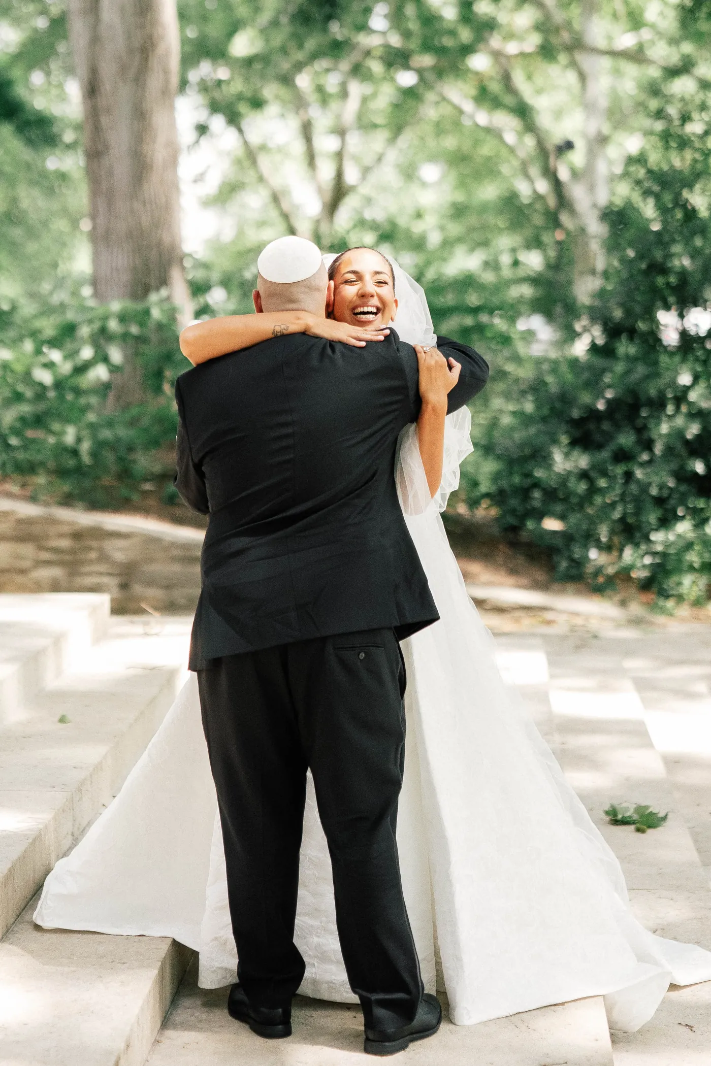 Gianna laughing as she hugs Simon after their first look
