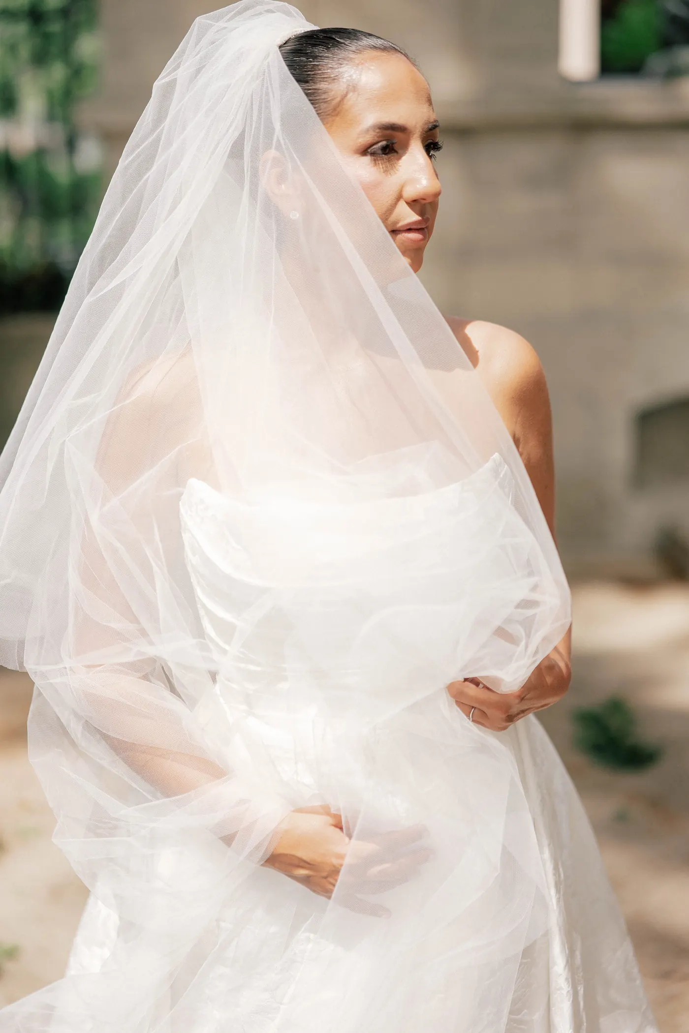 Gianna wrapped in her veil in soft afternoon light