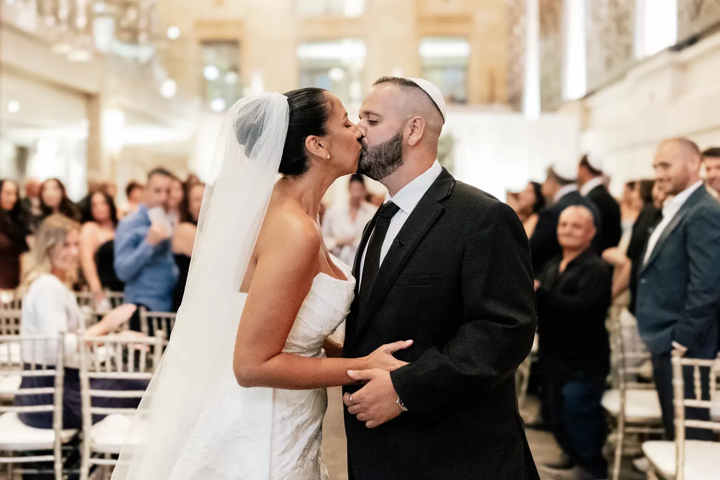 Gianna and Simon kissing in the aisle after the ceremony