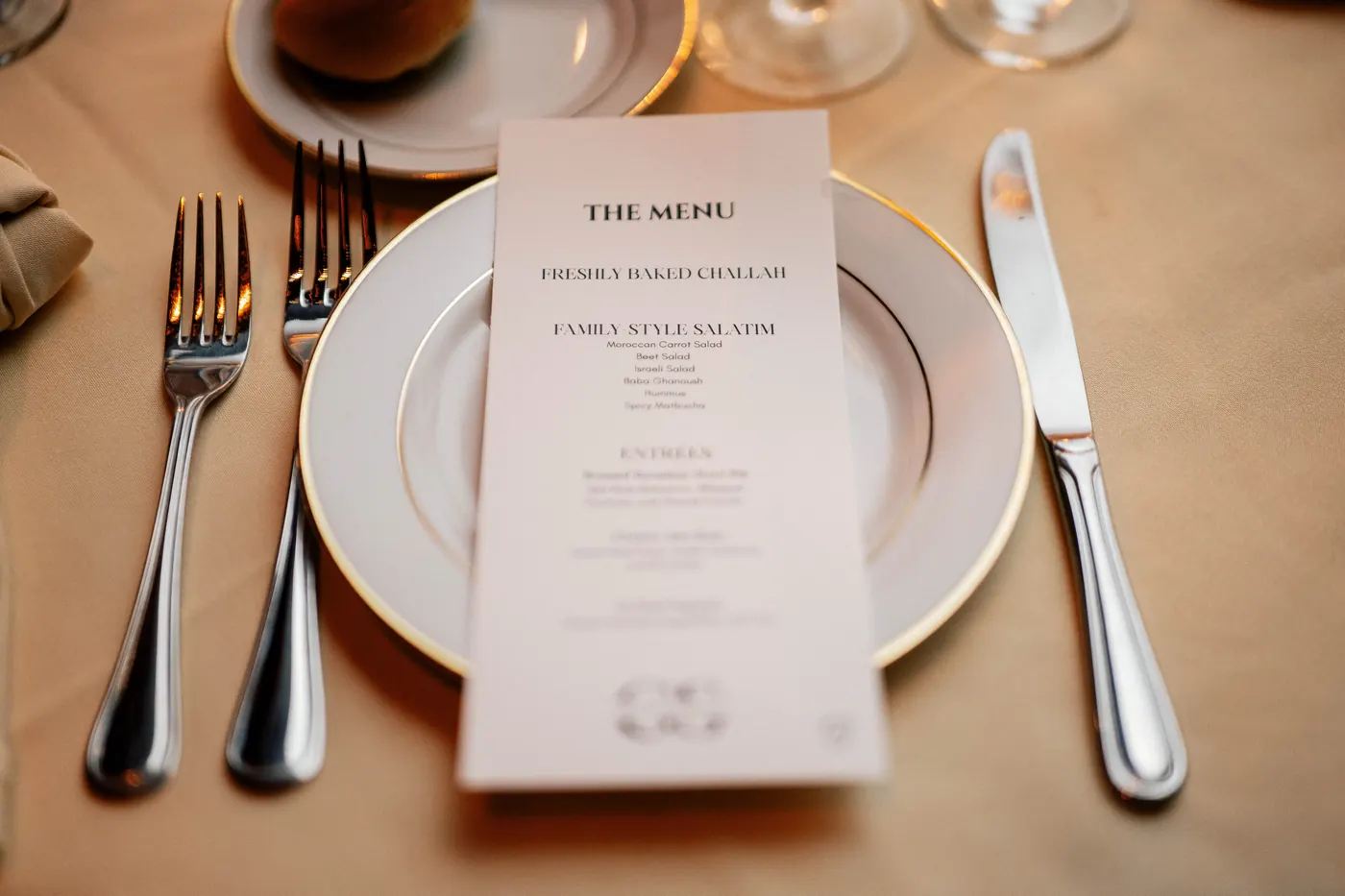 Reception menu card on a gold-rimmed plate