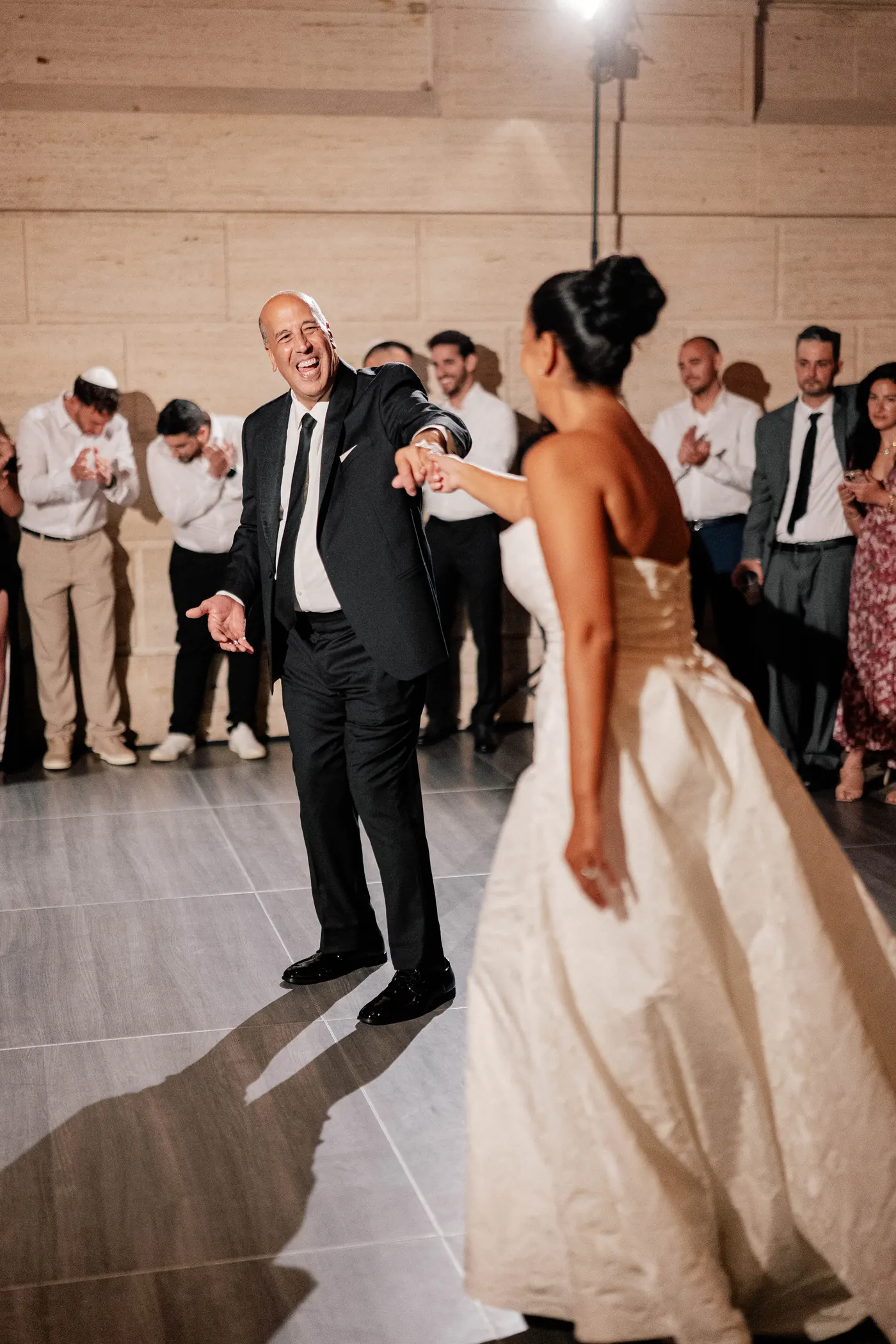 Gianna and her dad laughing together on the dance floor