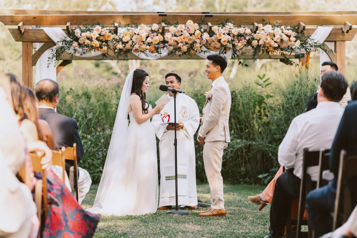 Camille and Ivan's ceremony beneath the floral pergola at Bishop Farmstead