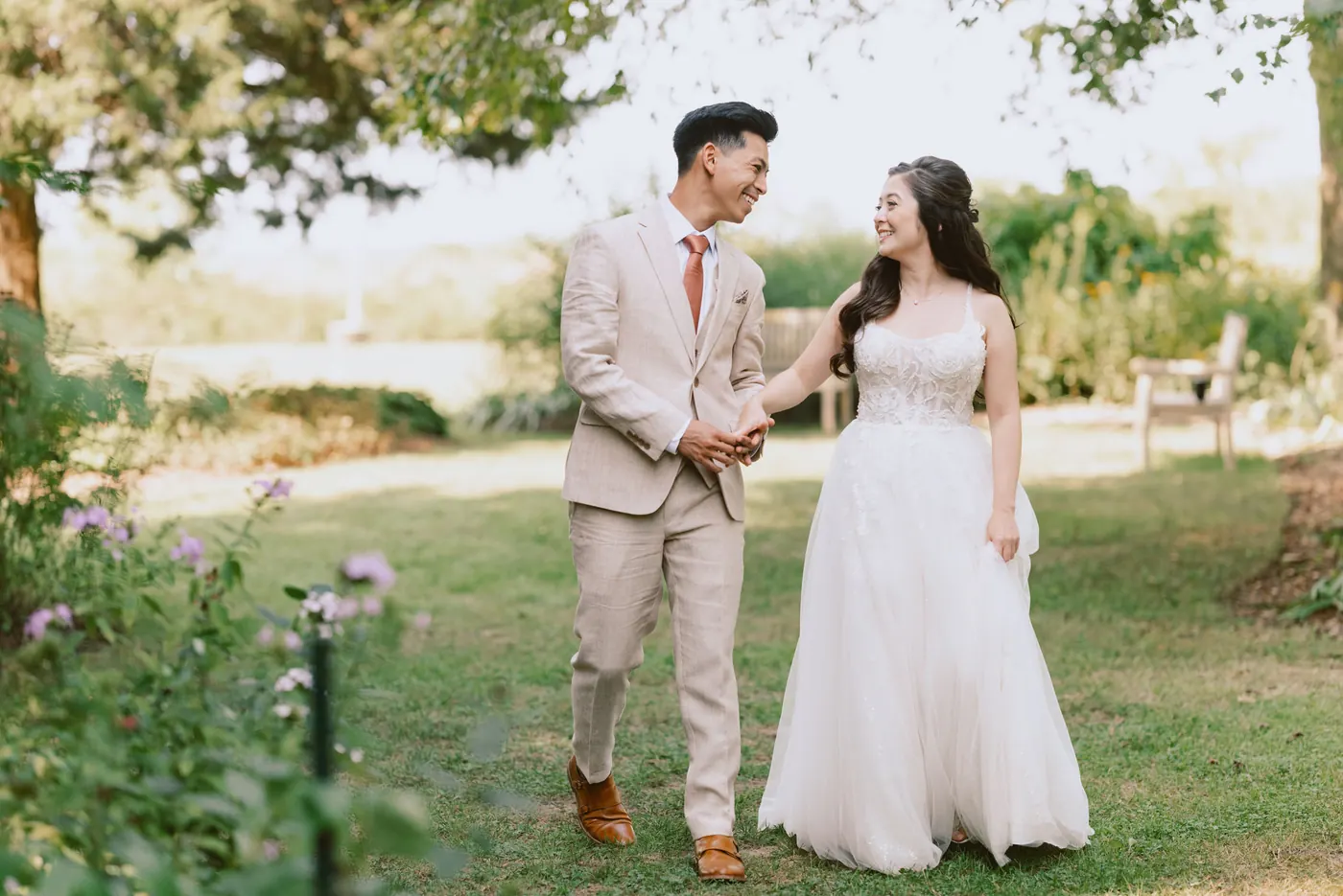 Ivan and Camille walking hand in hand through the gardens