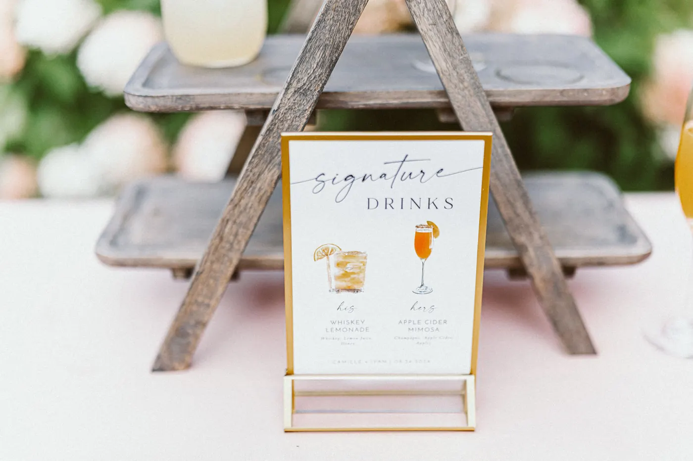 Signature drinks sign on a rustic wooden stand