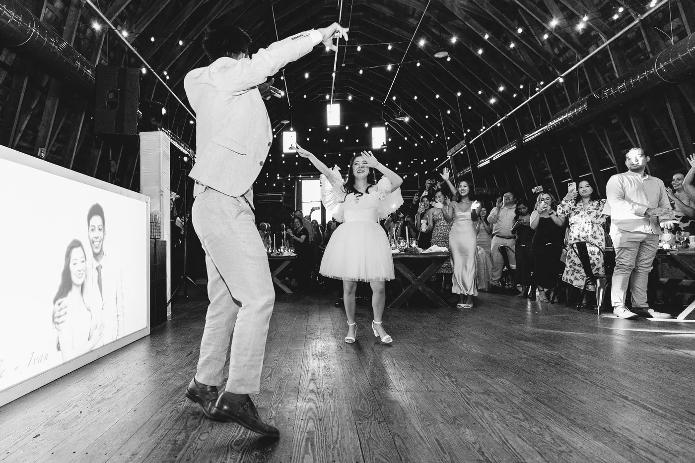 Black and white photo of Ivan and Camille dancing in the barn