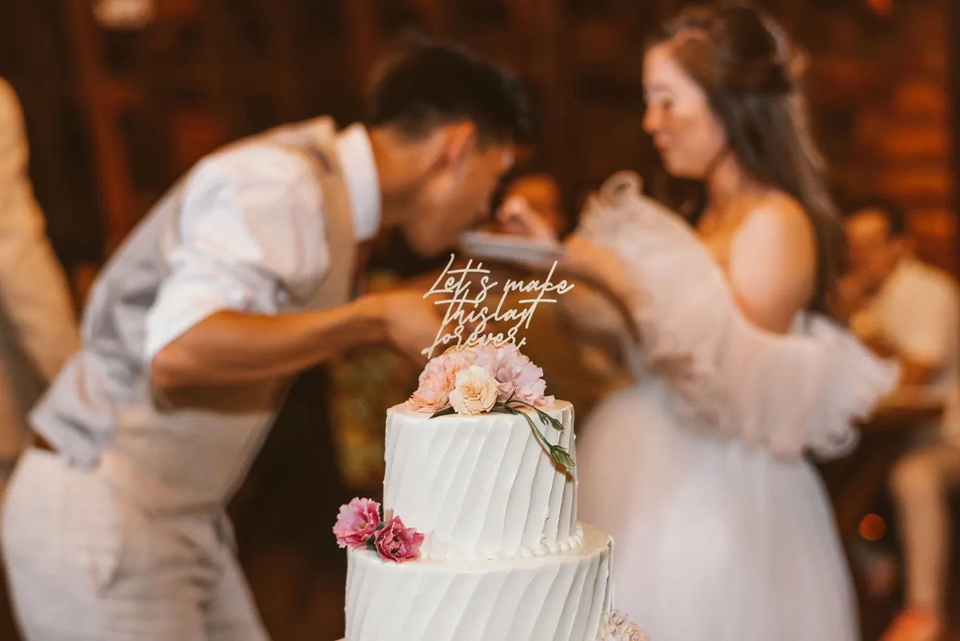 Camille and Ivan cutting their wedding cake