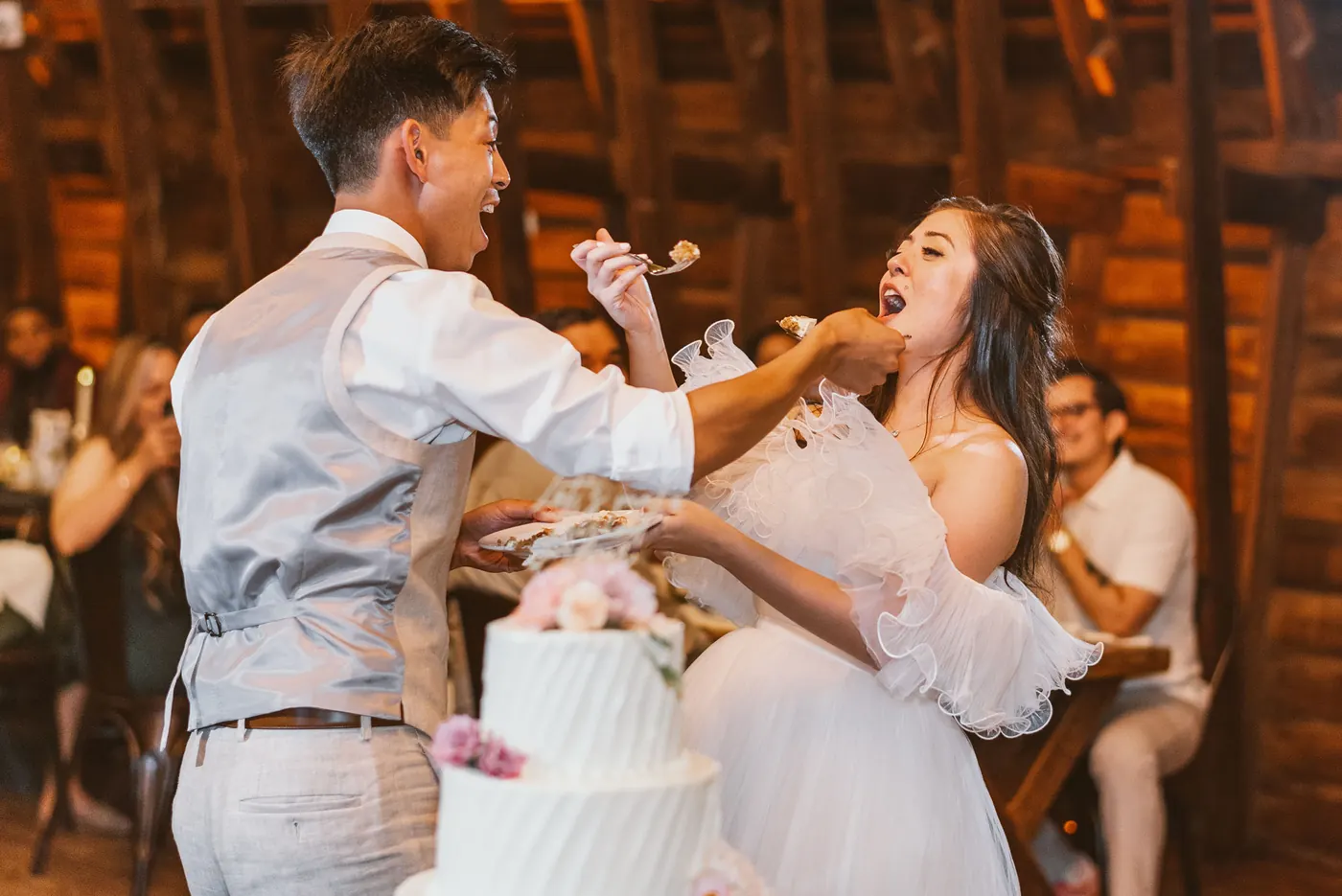 Camille and Ivan feeding each other cake