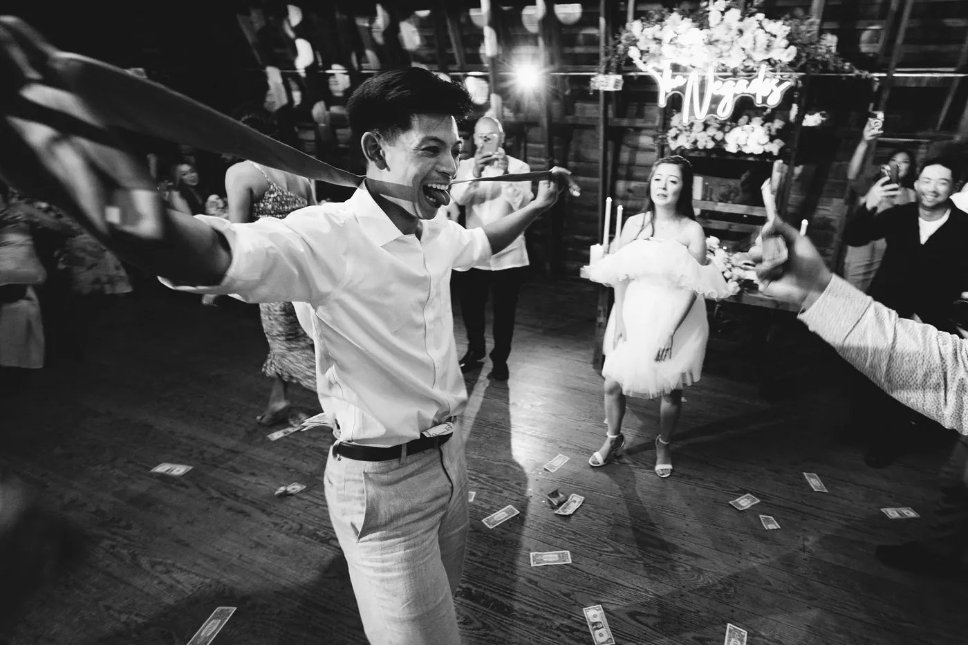 Black and white photo of Ivan dancing with money falling around him