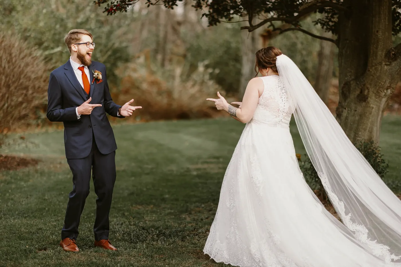 Jimmy and Kelsey pointing at each other and laughing as they see each other for the first time