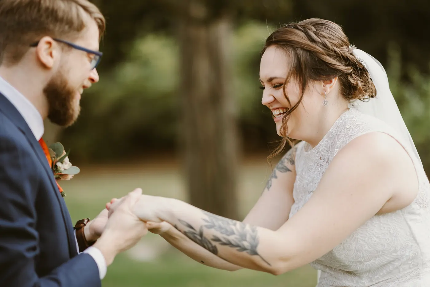 Kelsey laughing as she takes Jimmy's hands during their first look