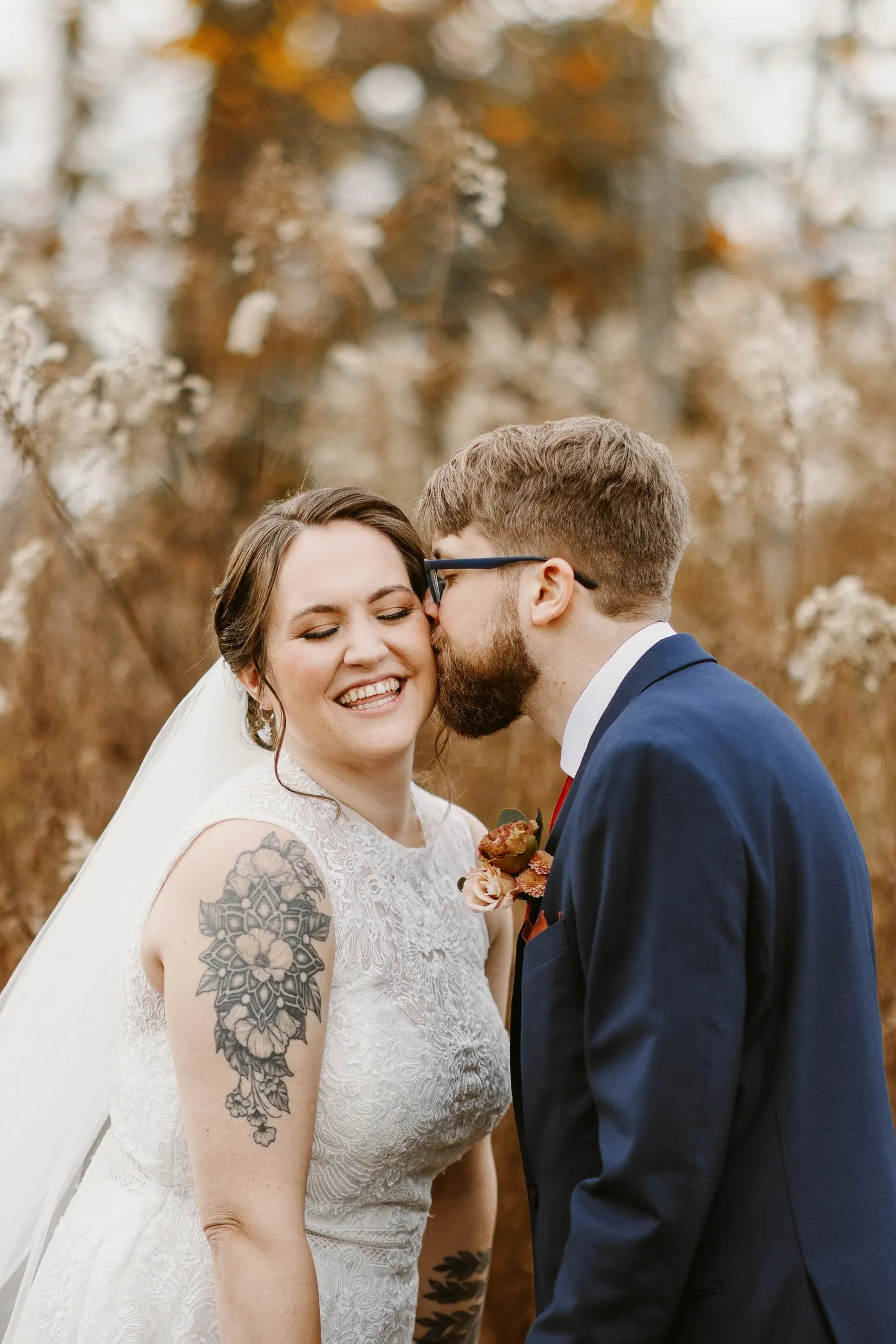 Jimmy kissing Kelsey's cheek in the tall autumn grasses