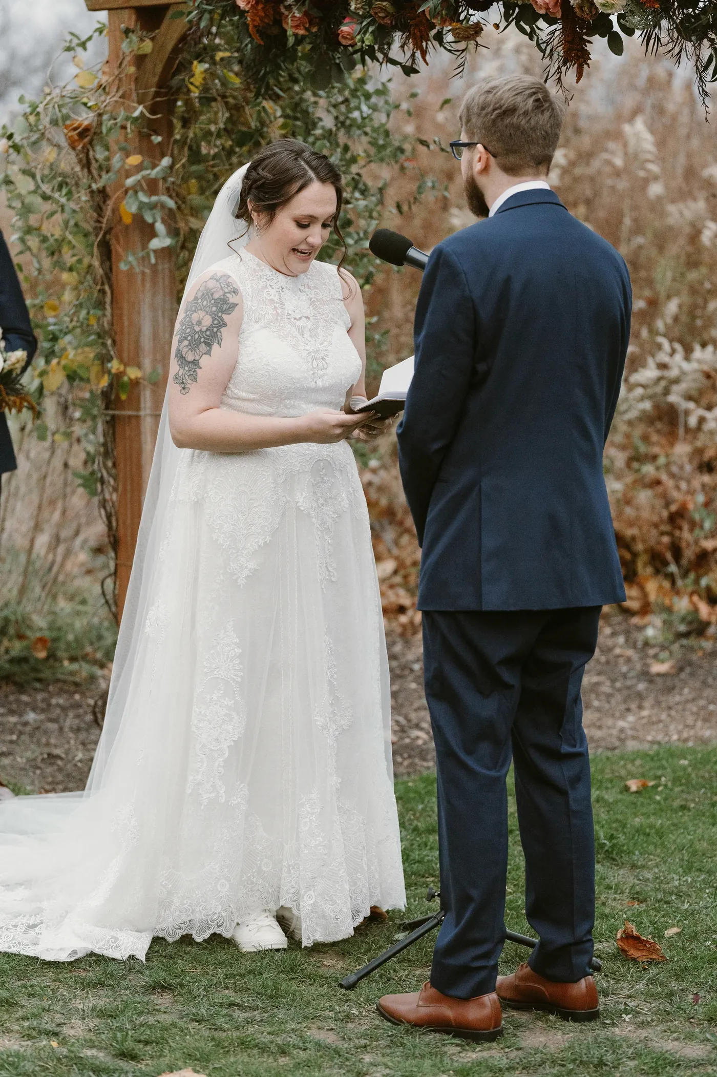 Kelsey reading her vows to Jimmy under the pergola