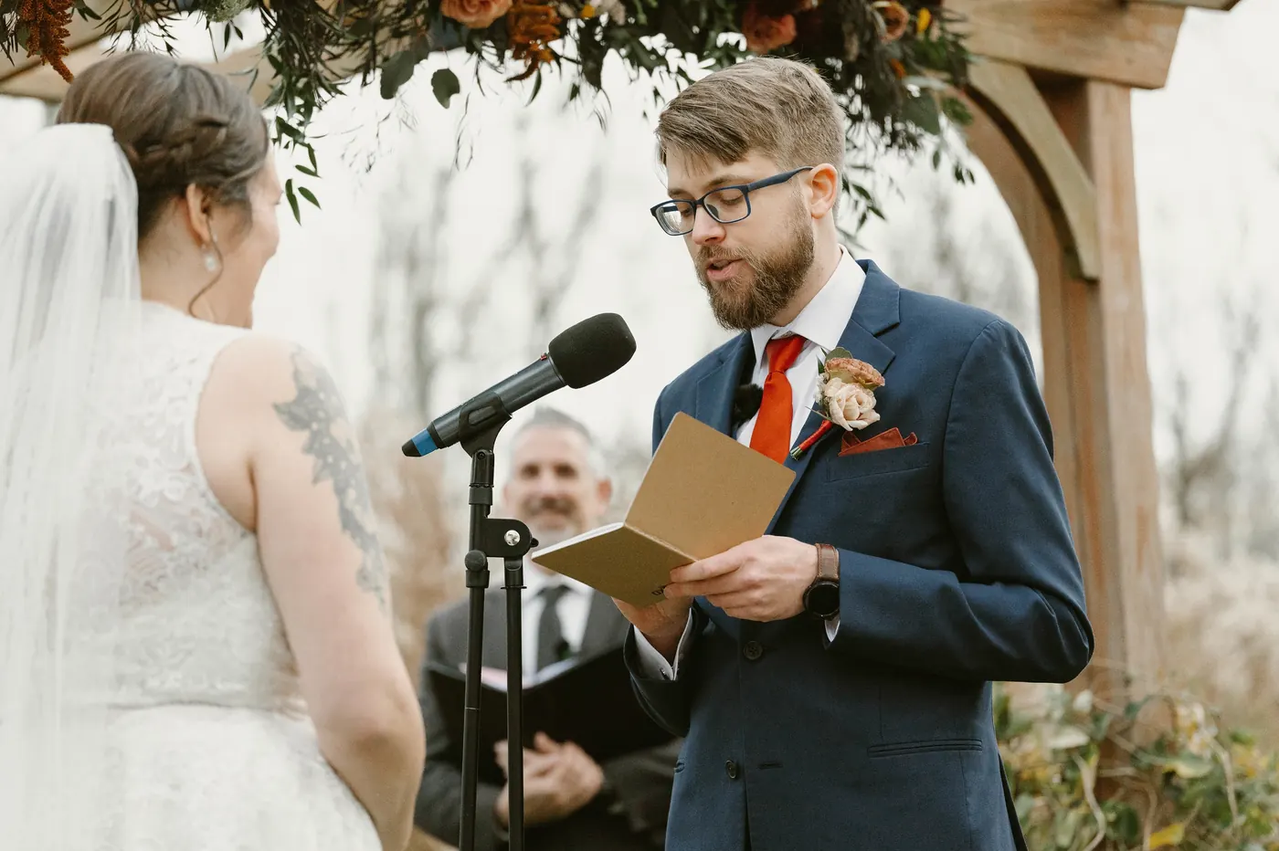 Jimmy reading his vows into the microphone