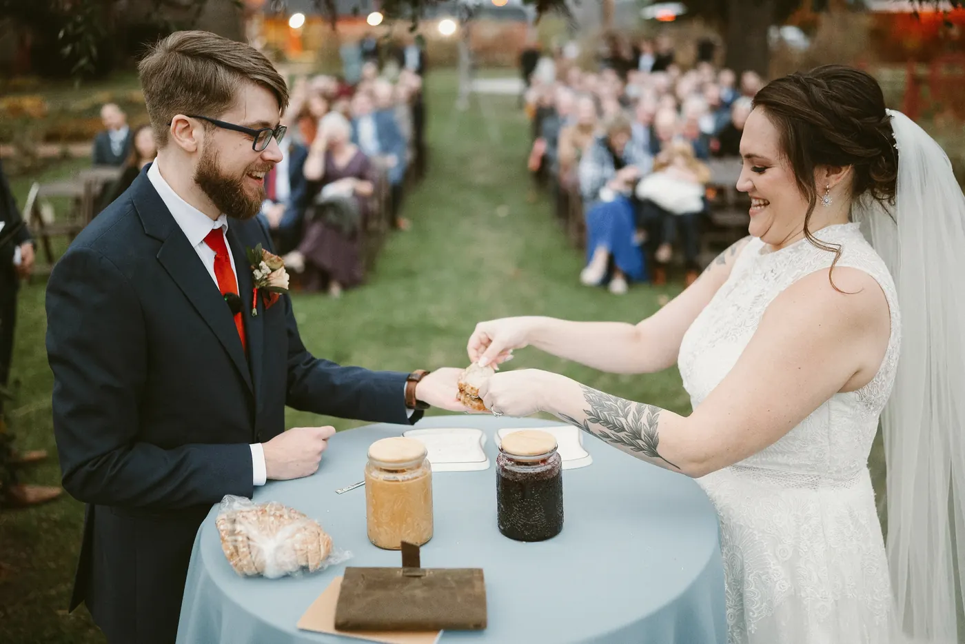 Jimmy and Kelsey pressing their sandwich together as guests watch