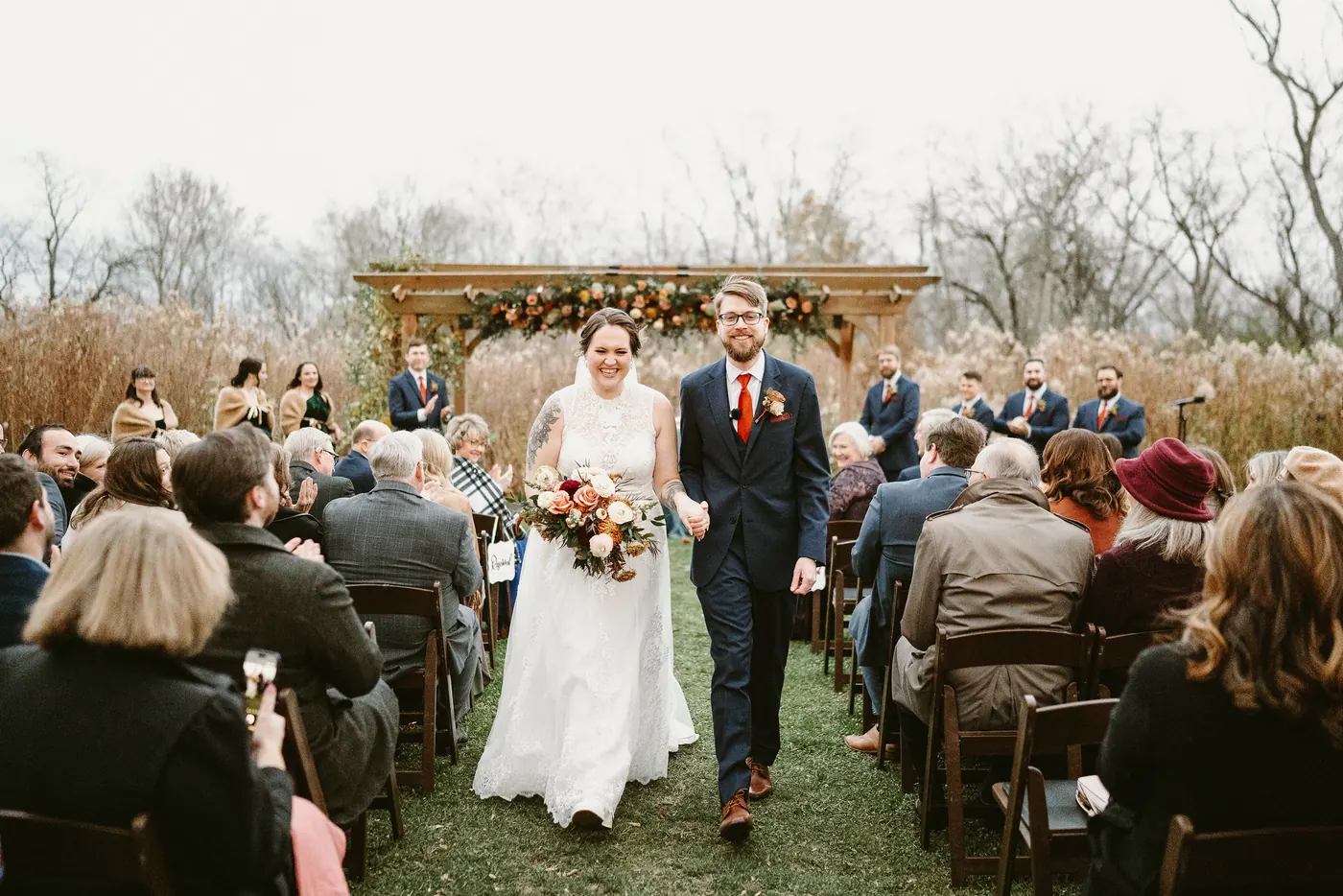 Jimmy and Kelsey walking back up the aisle married