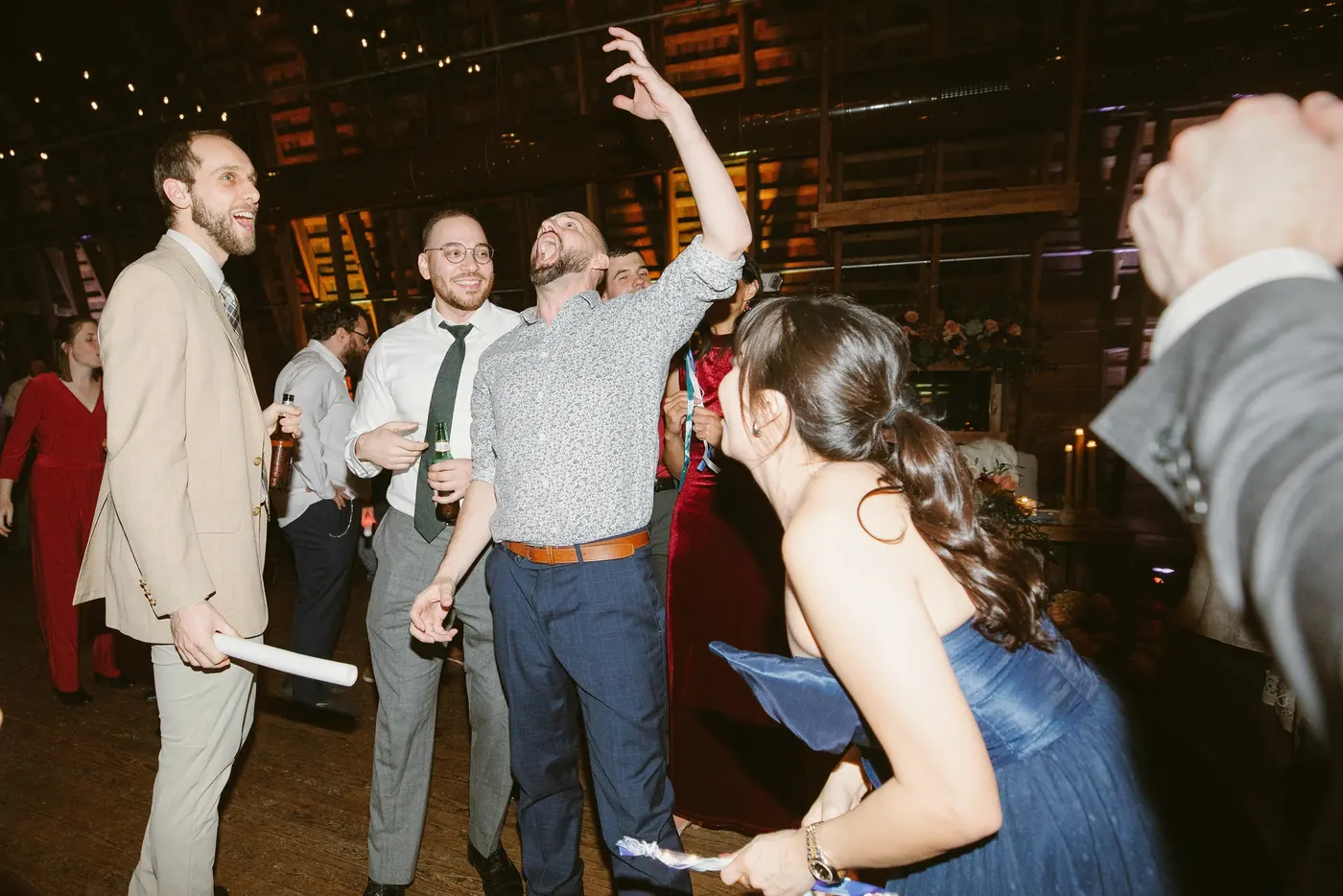 Guests cheering and dancing in the barn