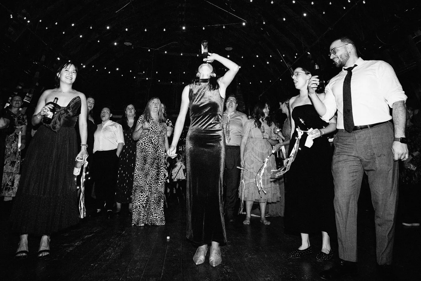 Black and white photo of guests celebrating on the dance floor