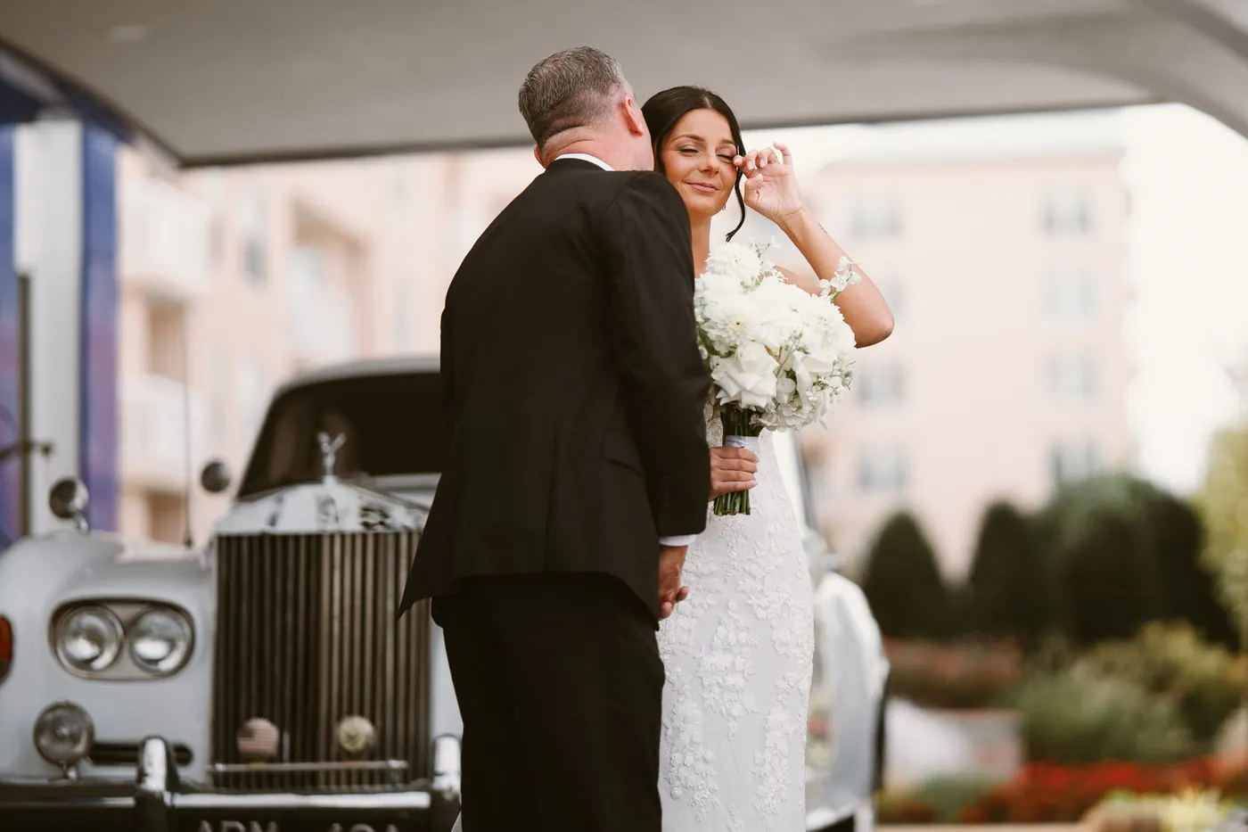 Morgan's dad hugging her after their first look beside the Rolls-Royce