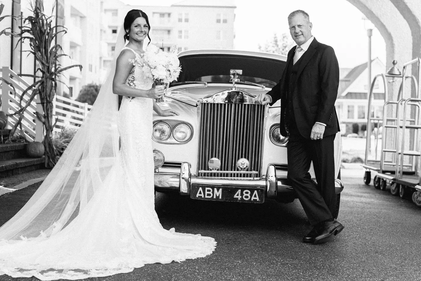 Black and white portrait of Morgan and her dad with the vintage Rolls-Royce