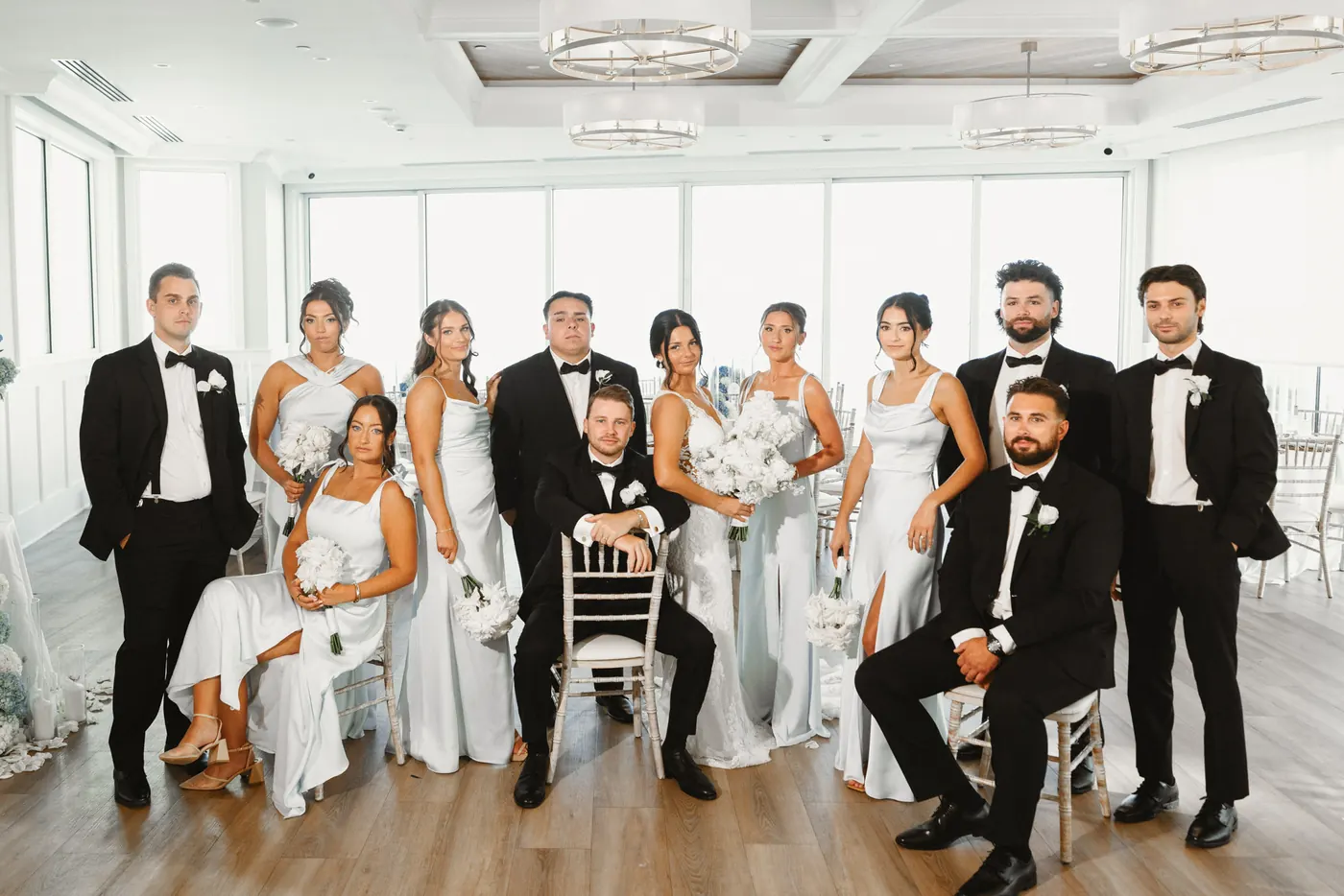 Mason and Morgan with their wedding party in the ballroom at ICONA Diamond Beach