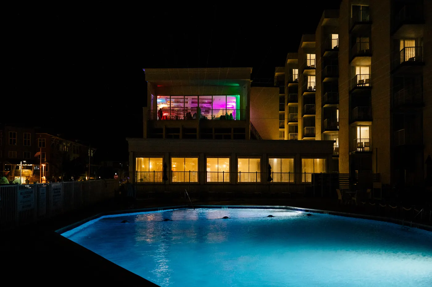 ICONA Diamond Beach at night with the pool glowing and the reception lit up above
