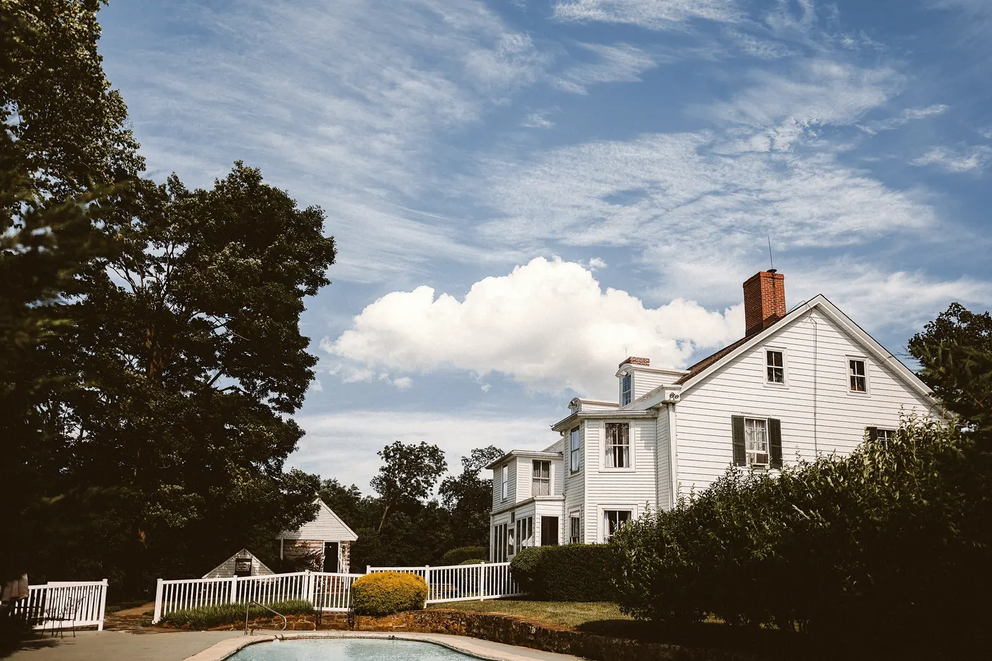 The white farmhouse under a bright summer sky at Johnson's Locust Hall Farm in Jobstown, NJ