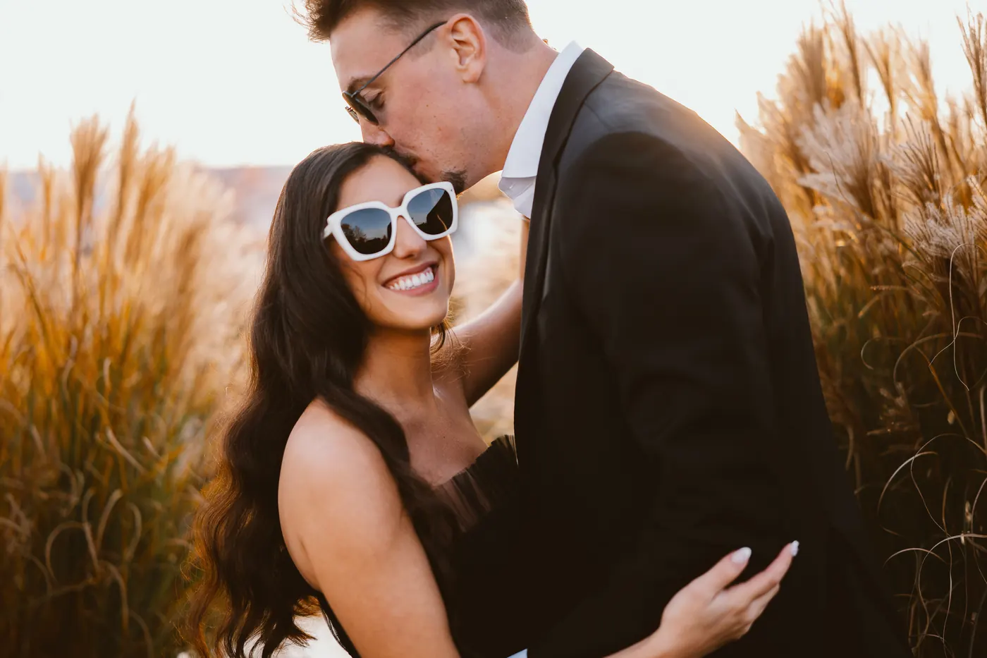 Will kissing Morgan's forehead as she smiles in golden hour light at Renault Winery in Egg Harbor City, NJ