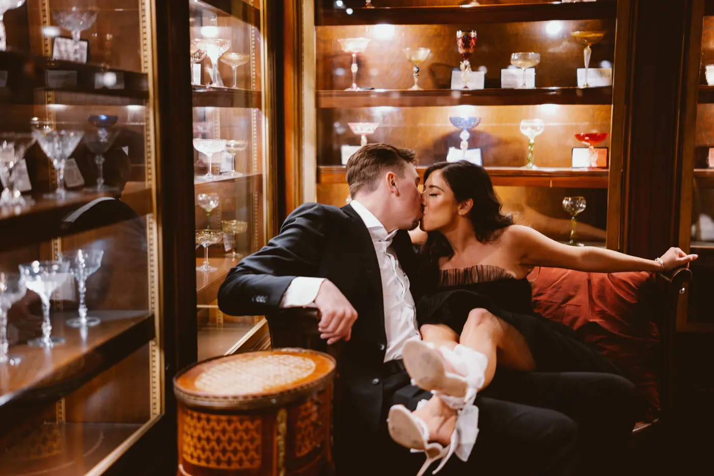 Morgan and Will kissing on the couch in the vintage tasting room