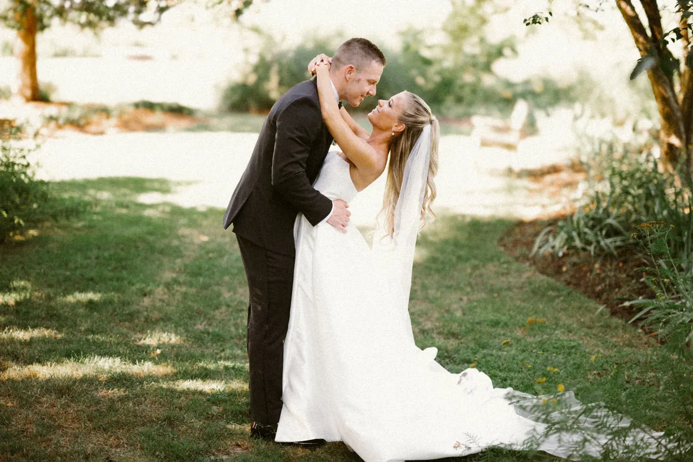 Steve dipping Madison for a kiss on the lawn