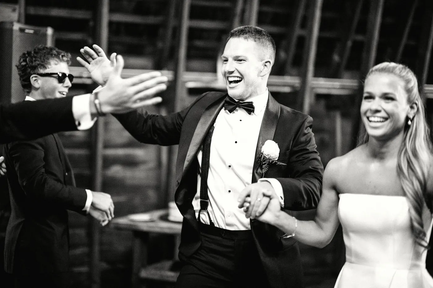 Steve high-fiving guests during the grand entrance, in black and white